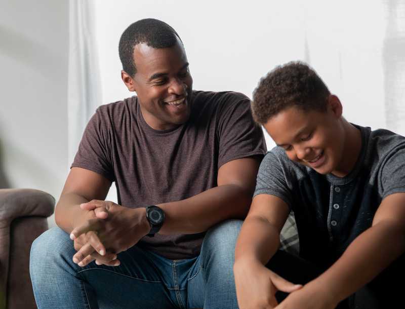 Father and son having a discussion on the couch