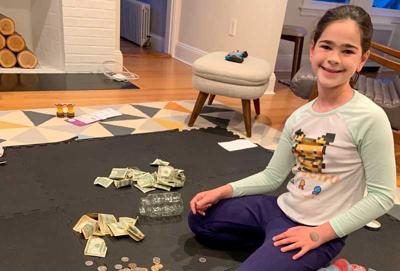 Emily counting various amounts of coin and papaer money.