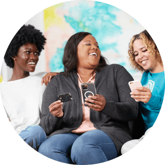 Parent holding a phone and a Till debit card with her two daughters by her side