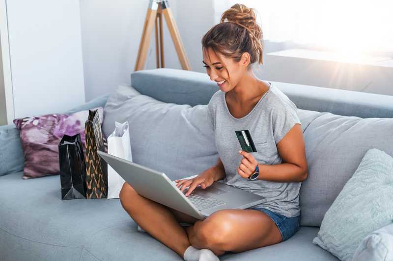 Teenager making a purchase online on their laptop using a Till debit card