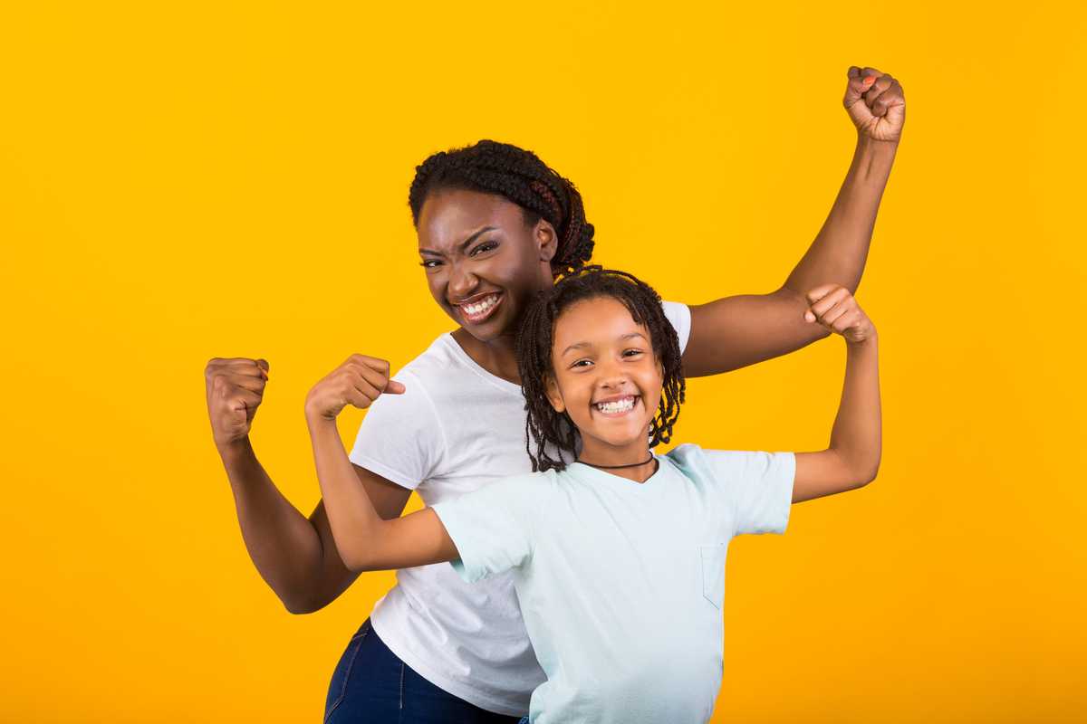 A mother and daughter flexing together for the camera